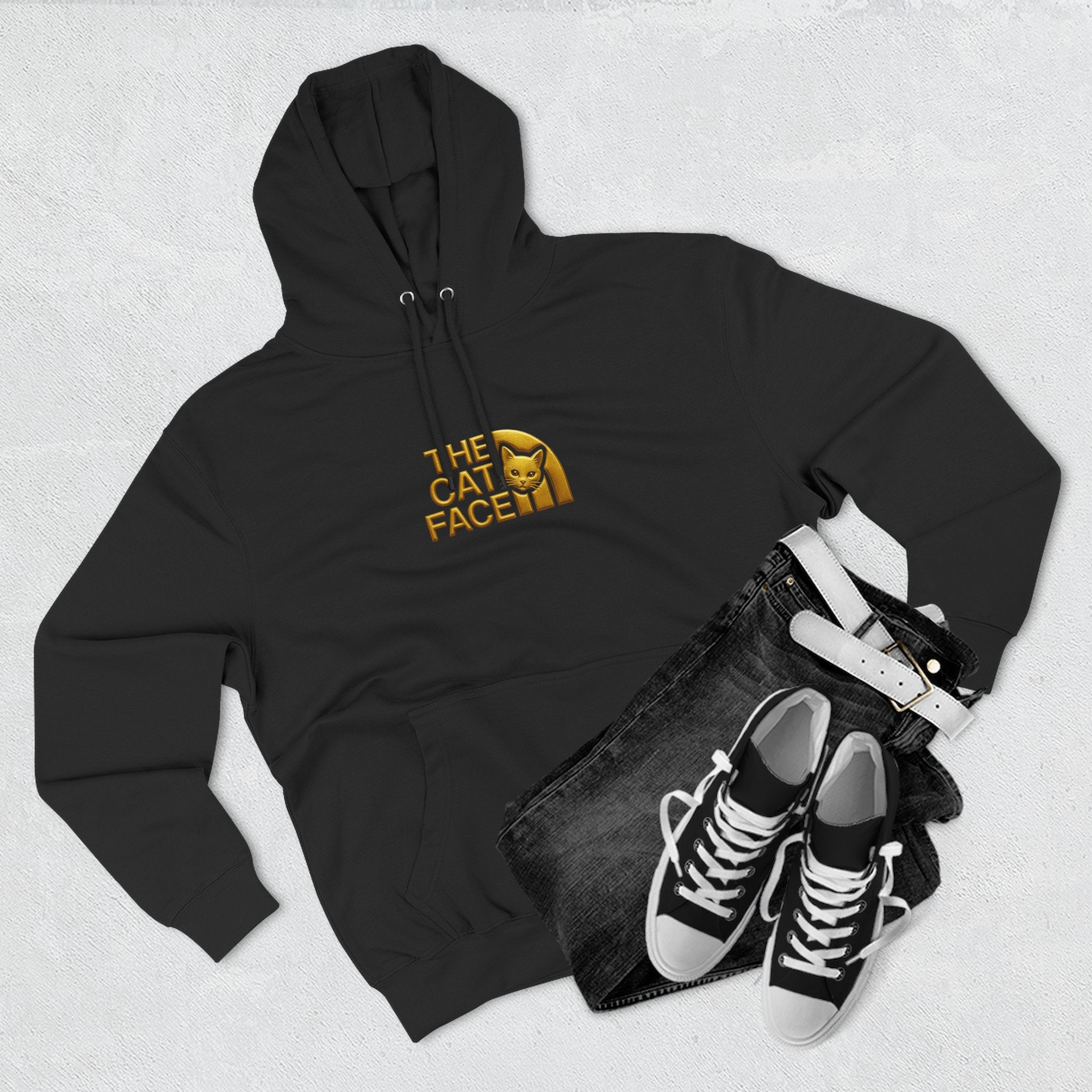 The Cat Face Gold Chest Logo & Back Puffer Cat Graphic Hoodie in black, flat lay