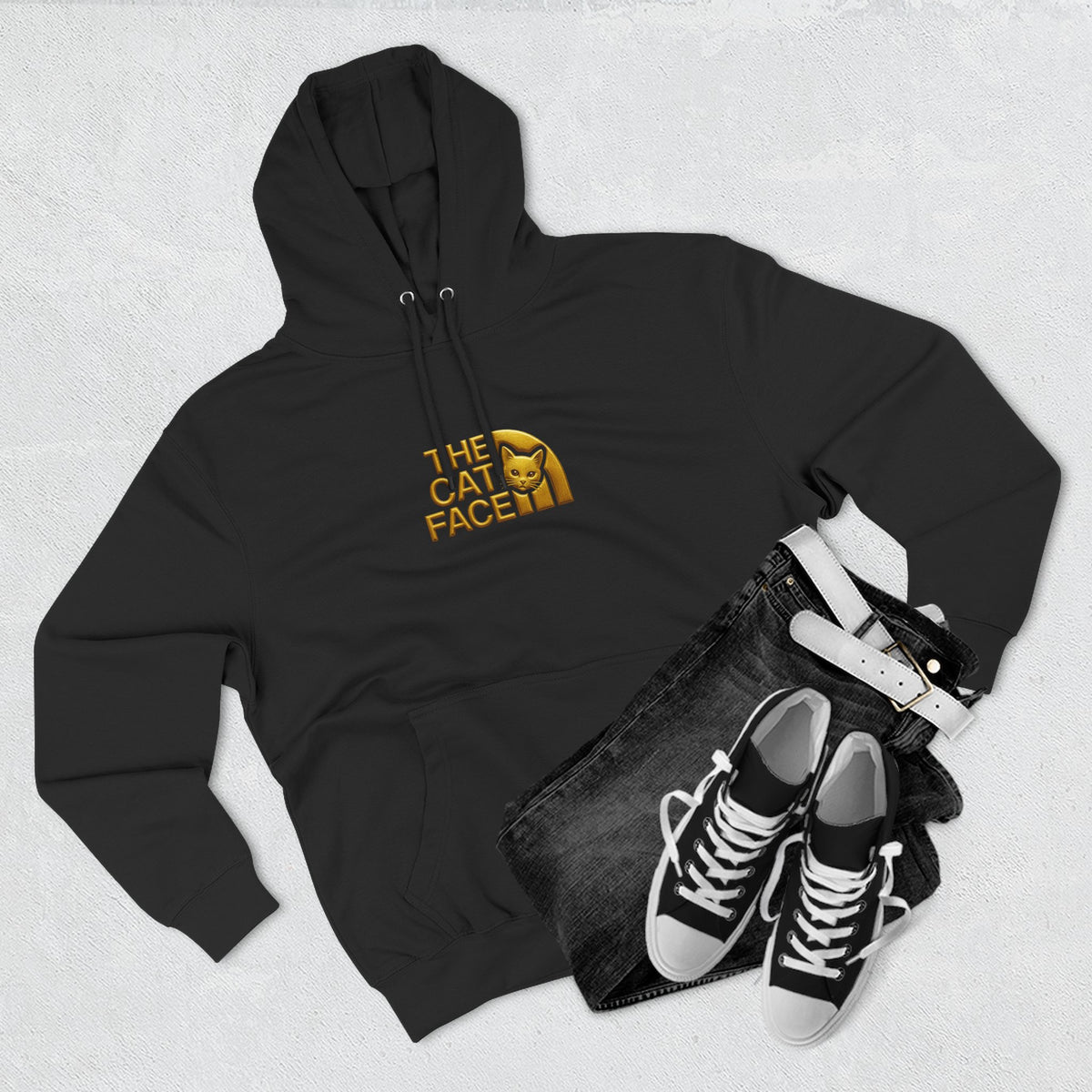 The Cat Face Gold Chest Logo & Back Puffer Cat Graphic Hoodie in black, flat lay