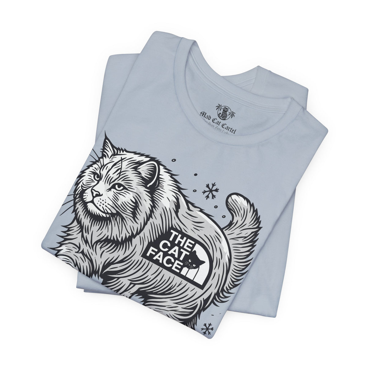 The Cat Face Snow Explorer Cat Graphic T-Shirt in light blue, folded