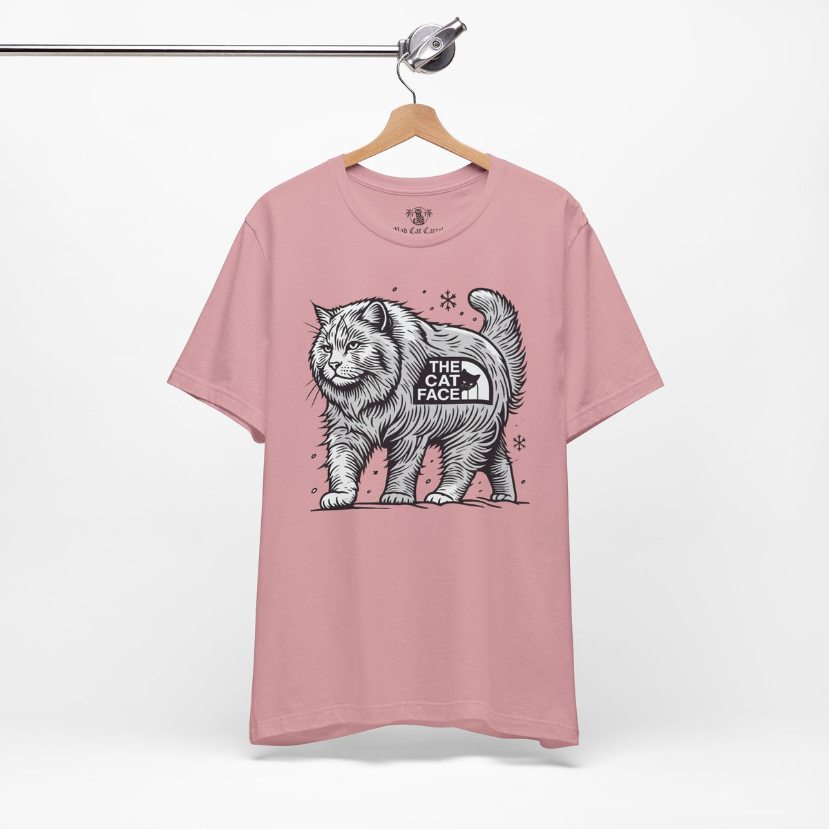 The Cat Face Snow Explorer Cat Graphic T-Shirt in orchid, on a hanger