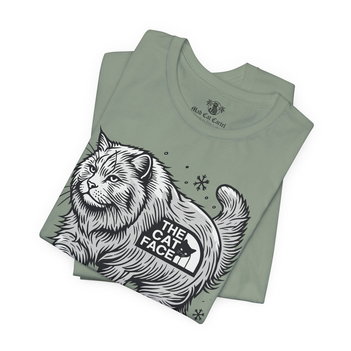 The Cat Face Snow Explorer Cat Graphic T-Shirt in sage, folded