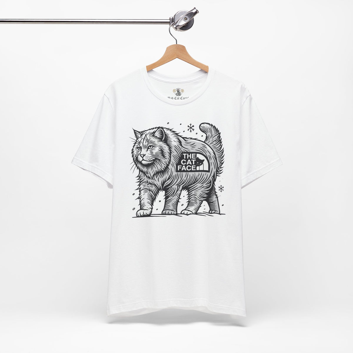 The Cat Face Snow Explorer Cat Graphic T-Shirt in white, on a hanger