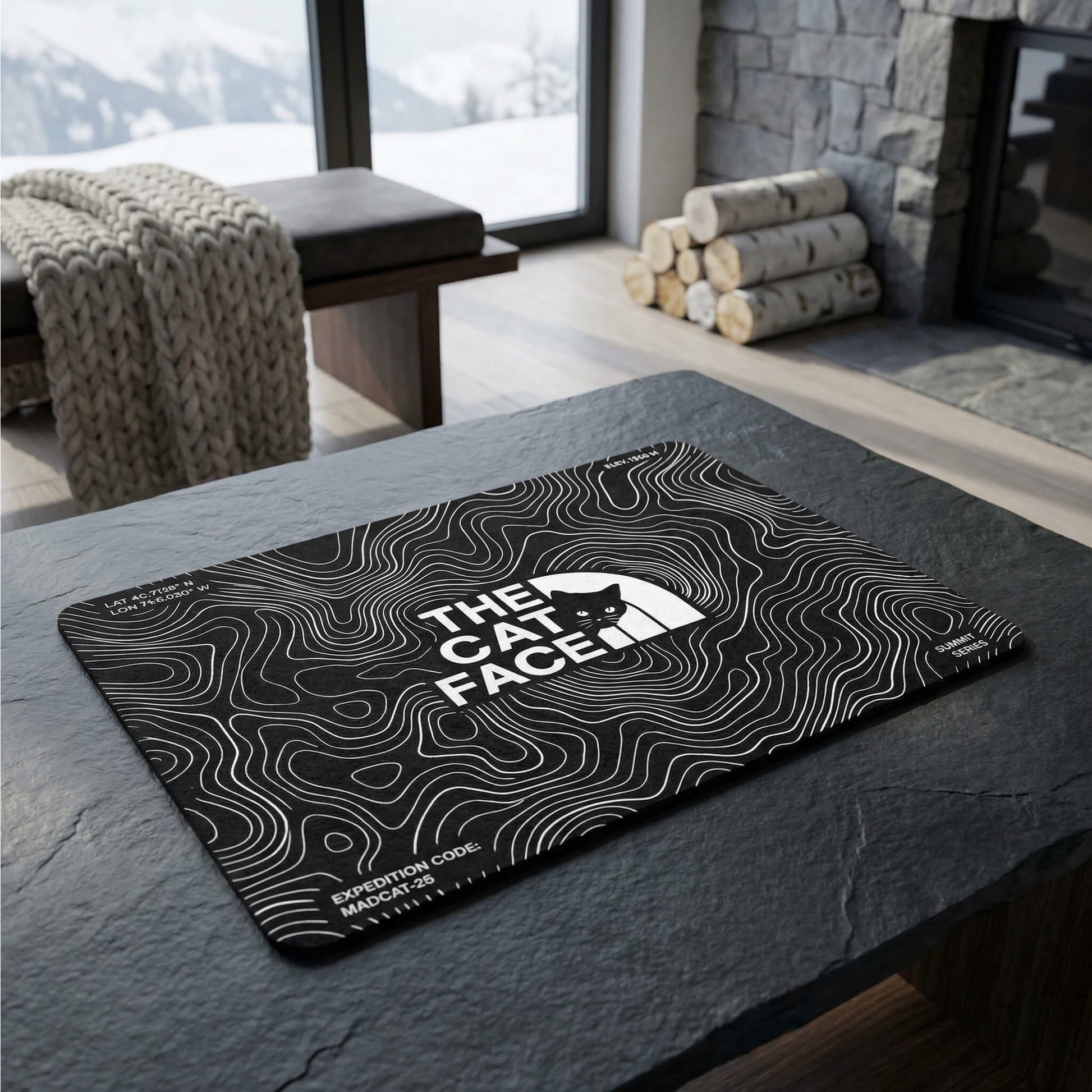 The Cat Face black feeding station mat for cats with contour map artwork in a mountain style room