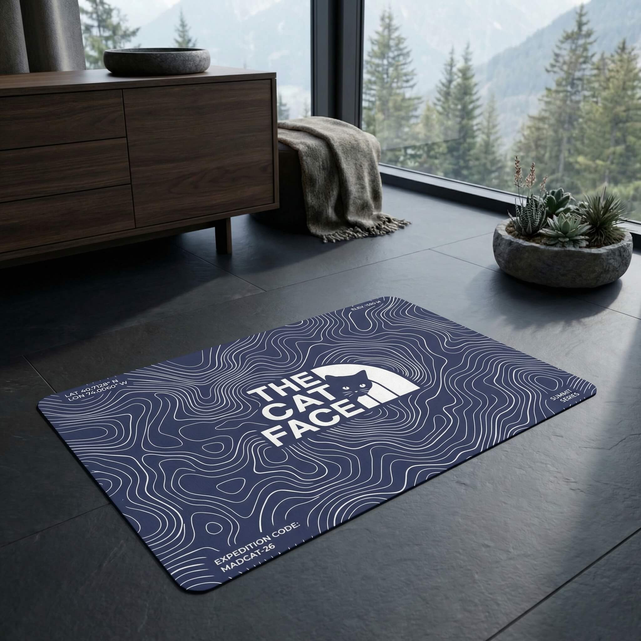 The Cat Face Summit Terrain Designer Cat Feeding Mat in blue, in a home setting