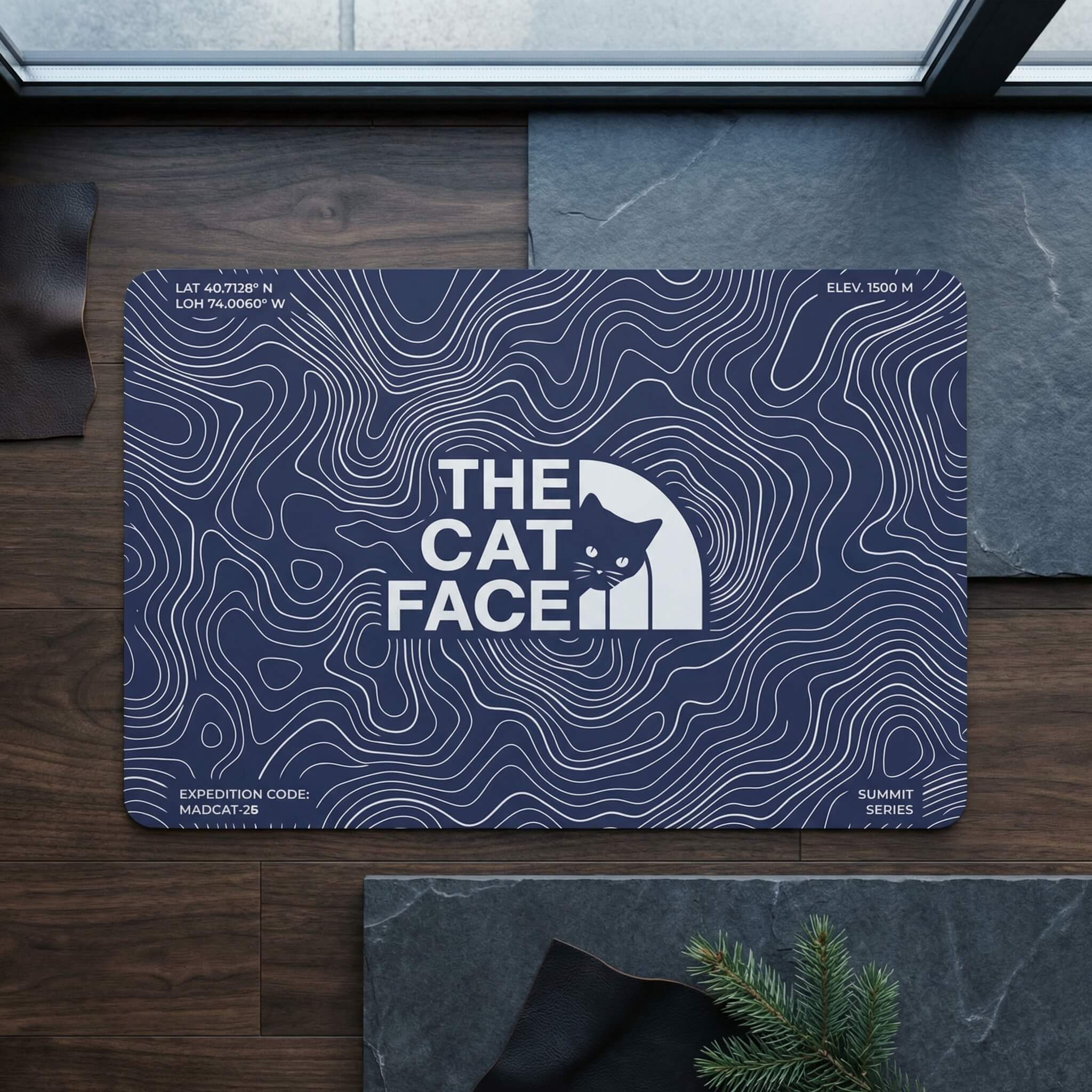 The Cat Face Summit Terrain Designer Cat Feeding Mat in blue, in a home setting
