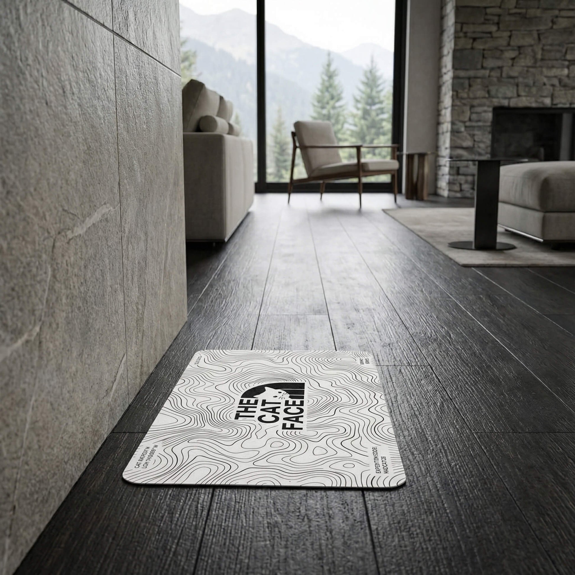 The Cat Face cat feeding mat on dark floor white topo line mat by Mad Cat Cartel