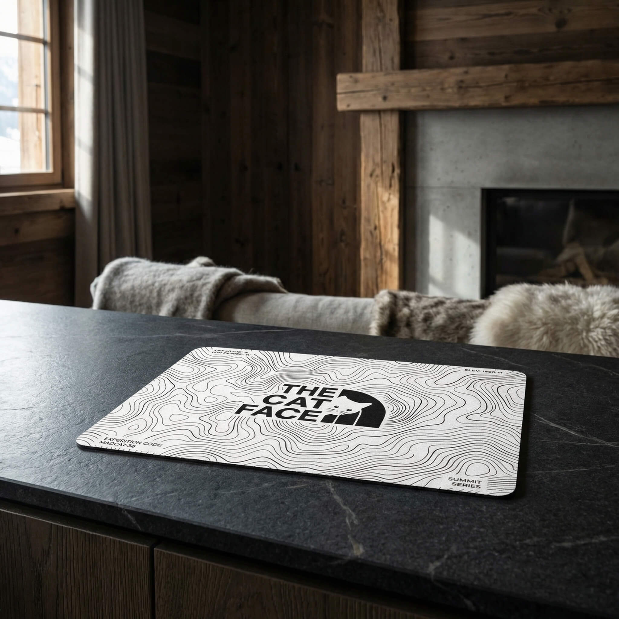 The Cat Face Summit Terrain cat feeding mat on dark surface by Mad Cat Cartel