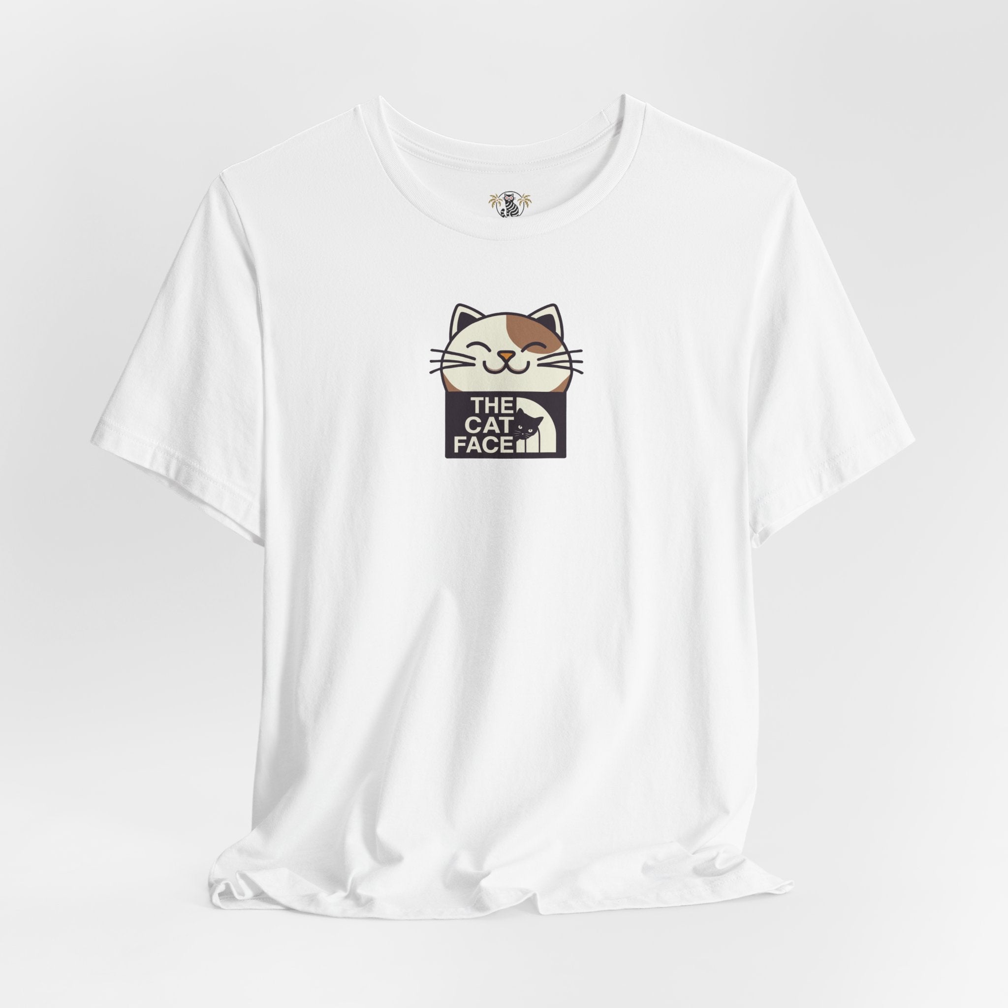The Cat Face Winking Cat Logo Graphic T-Shirt in white, flat lay