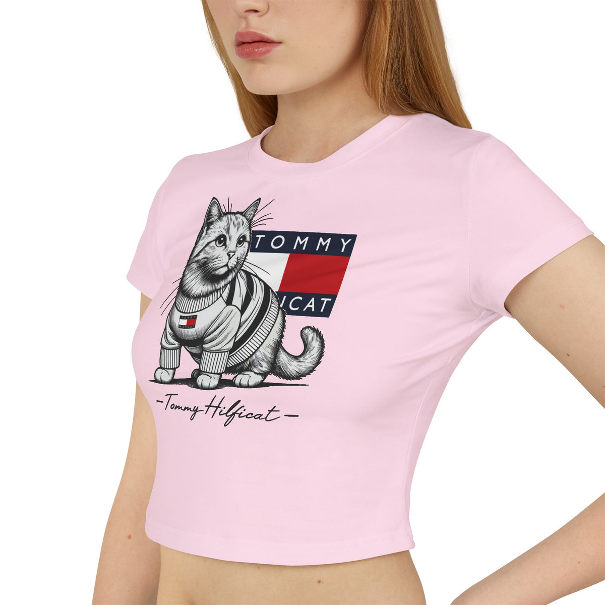 Tommy Hilficat Signature Purr Style Cat Graphic Women's Baby Tee in light pink, worn by a female model