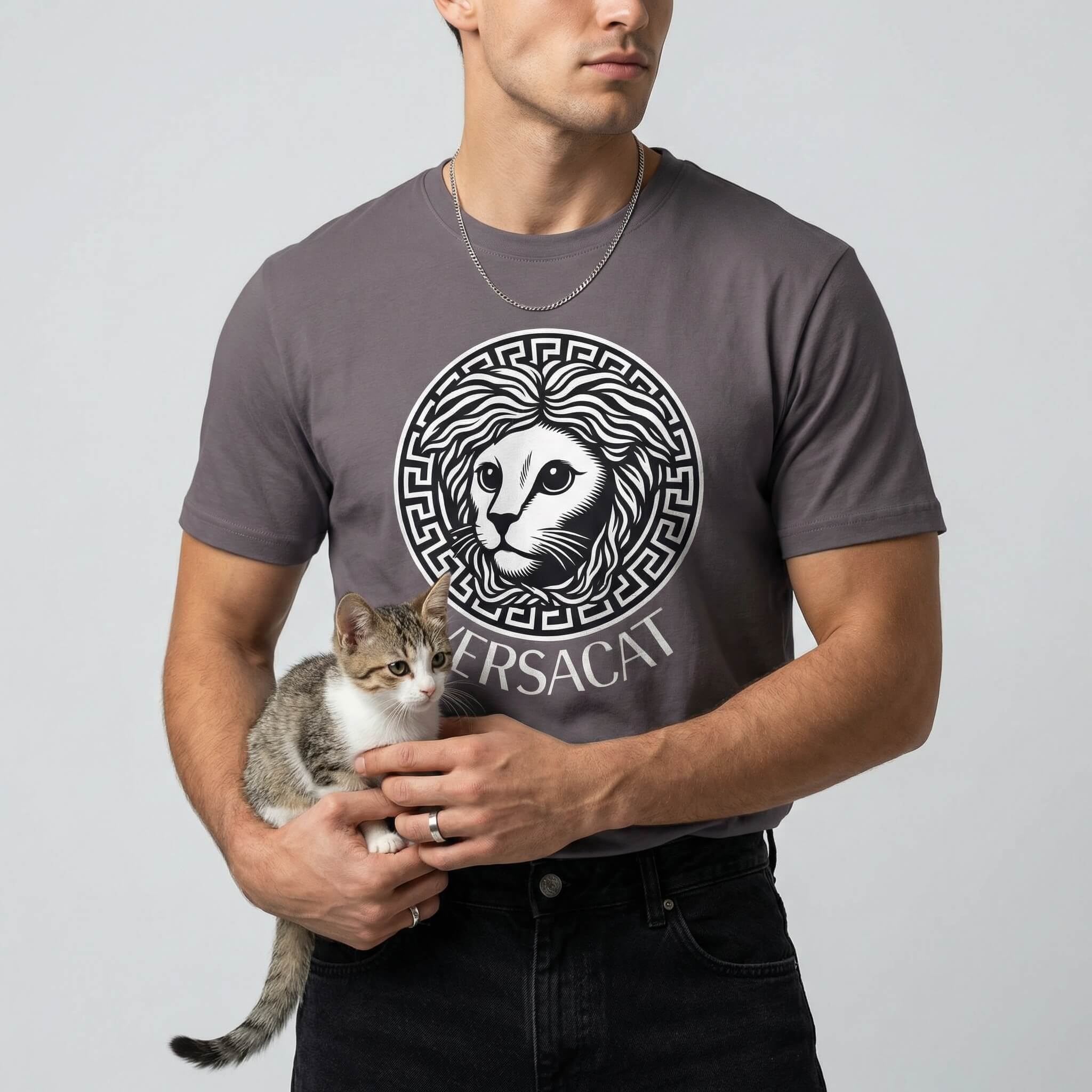 Versacat designer parody cat tee by Mad Cat Cartel in storm gray worn by male model holding kitten with front emblem graphic
