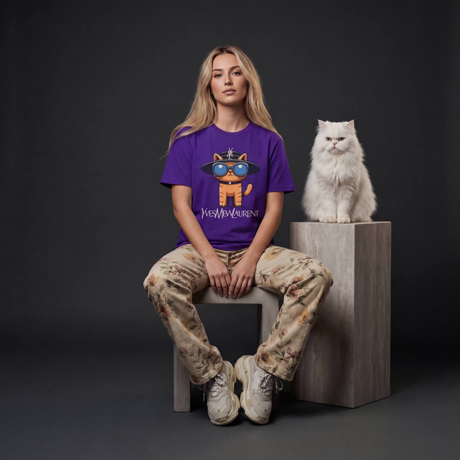 female model wearing Yves Mew Laurent cat graphic t shirt by Mad Cat Cartel in team purple with white cat beside her